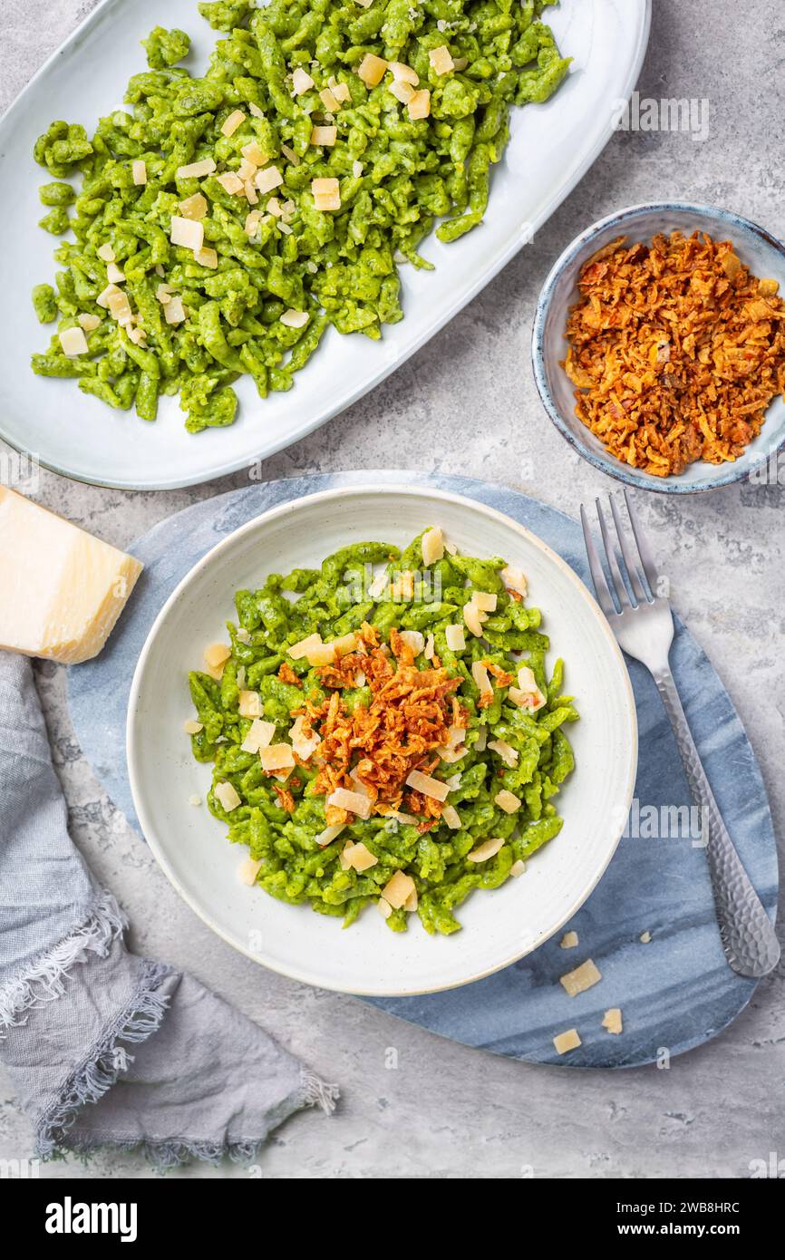 Spinach spaetzle with parmesan and roasted onions - German egg noodles Stock Photo