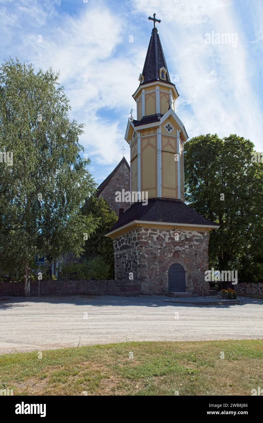 Wooden bell tower of old stone Pertteli church in summer, Pertteli, Finland. Stock Photo