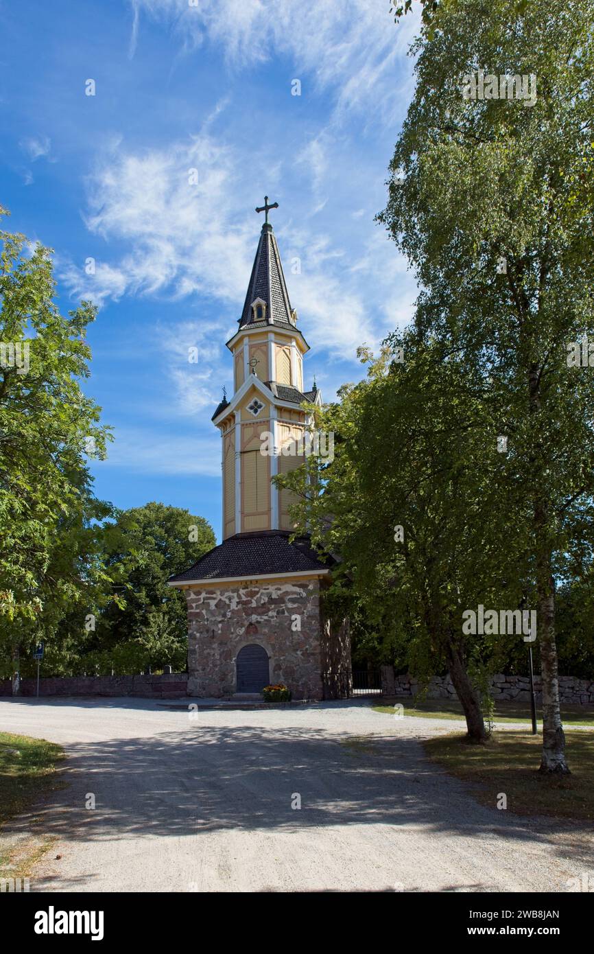 Wooden bell tower of old stone Pertteli church in summer, Pertteli, Finland. Stock Photo