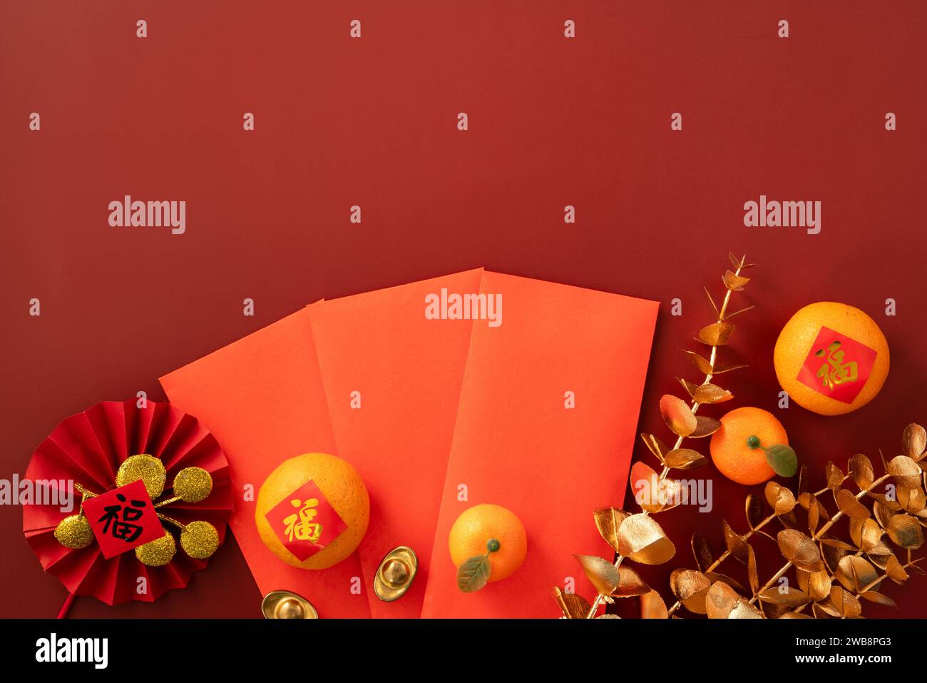 Chinese lunar new year background with fresh tangerine, red envelope, paper fan and decorations for Spring Festival and the word means fortune. Stock Photo