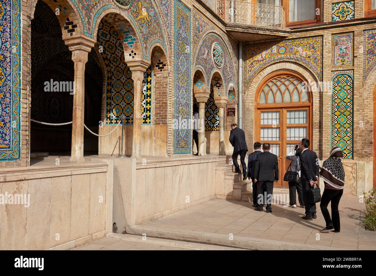 Visitors in business suits enter the Karim Khani Nook, a structure in the Golestan Palace, dating back to 1759. Tehran, Iran. Stock Photo