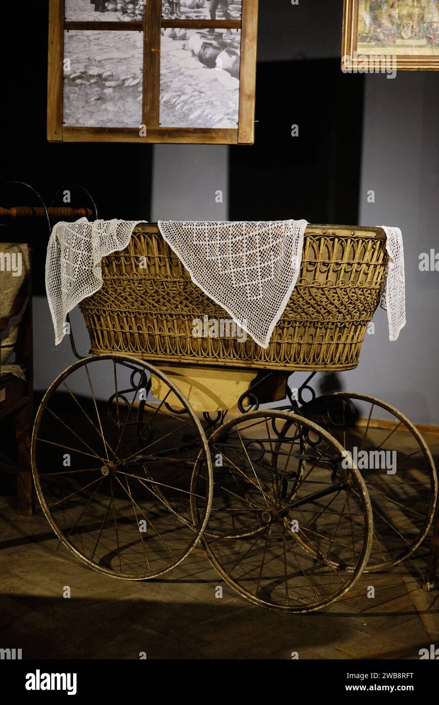 Lviv, Ukraine - November 10, 2021: Vintage Scandinavian baby stroller. Wicker baby carriage. Stock Photo