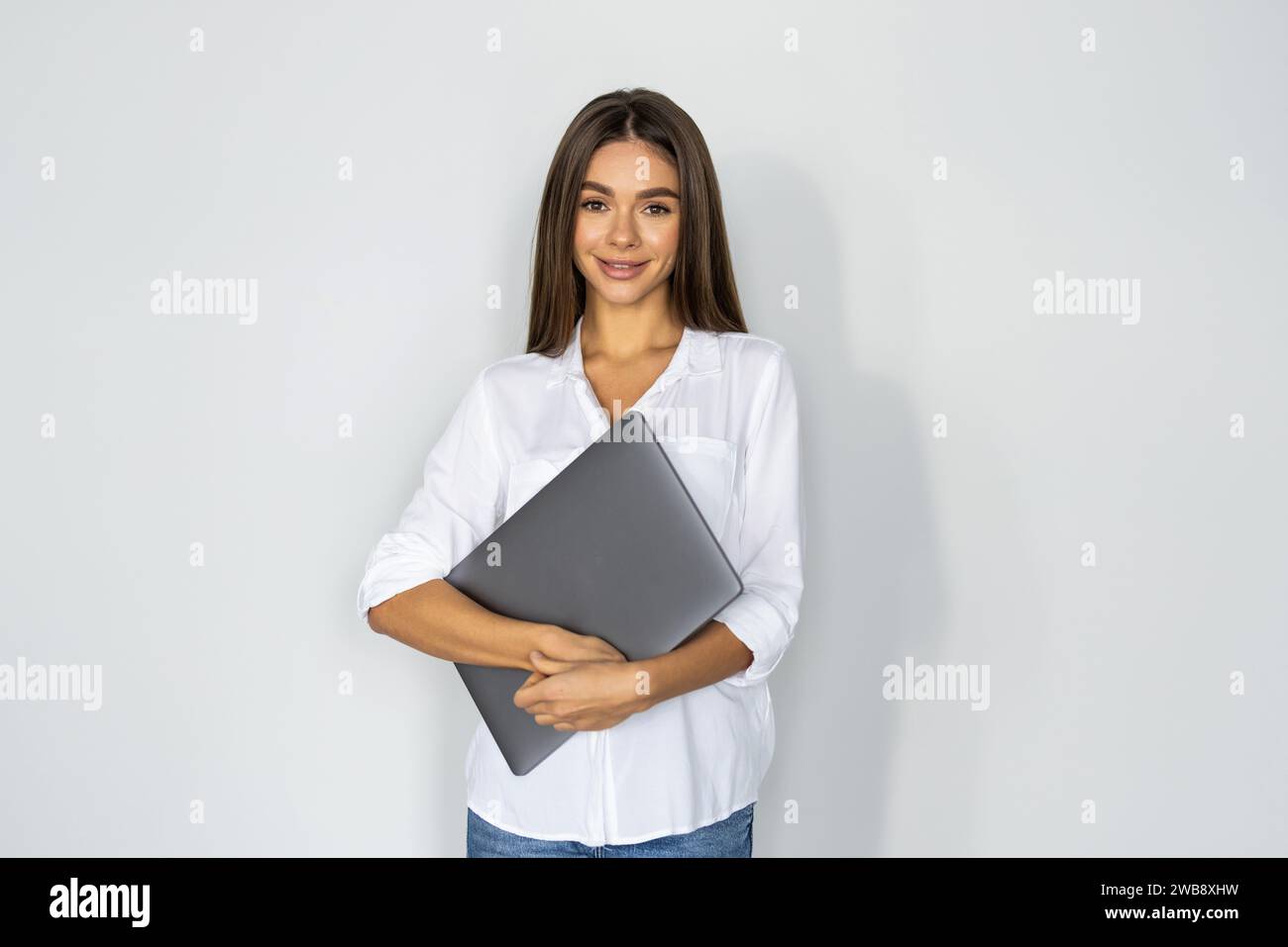 Young woman with laptop on white background Stock Photo - Alamy