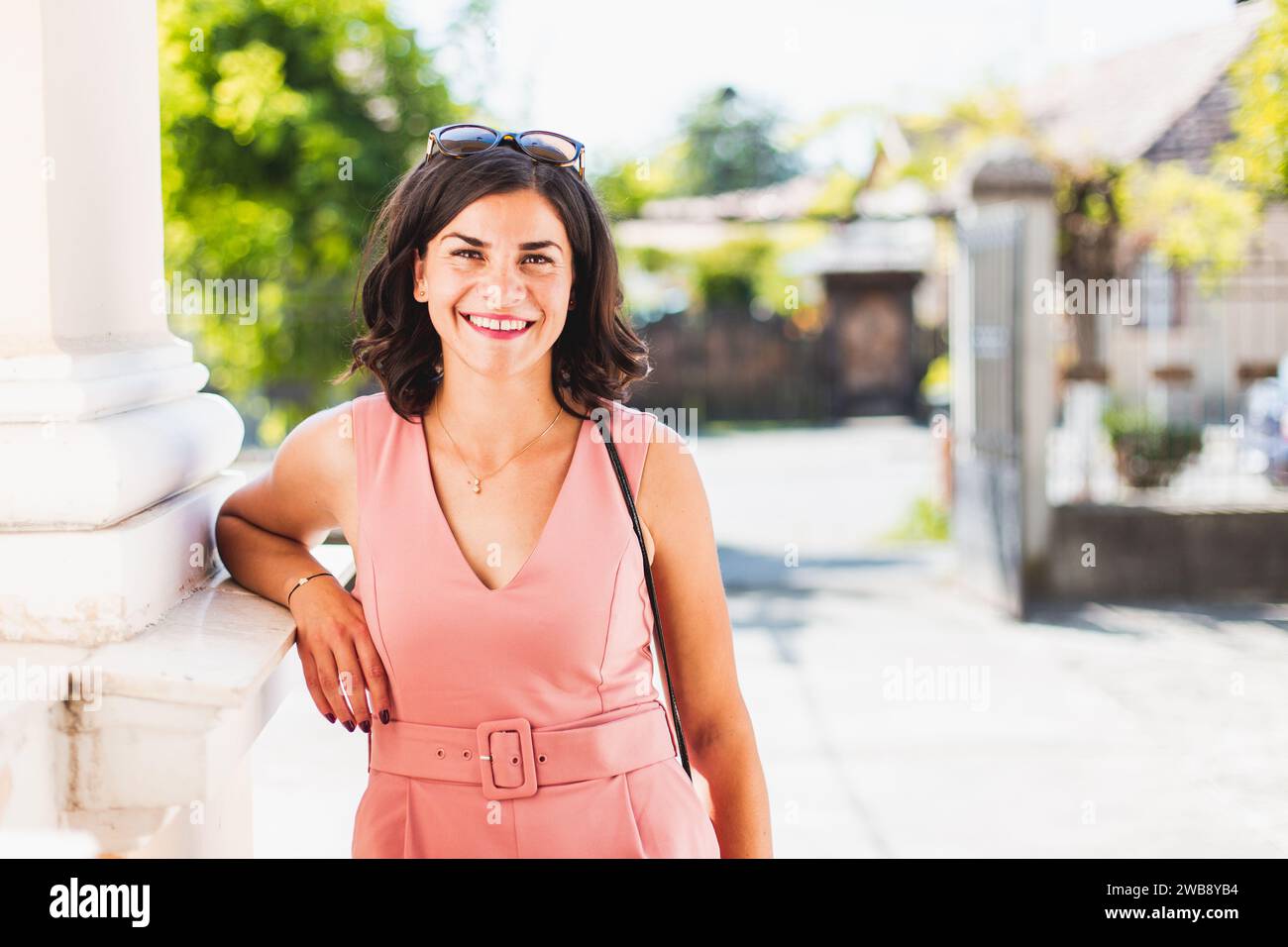 Young woman smiling in camera. Happy summer colours, blurry background Stock Photo