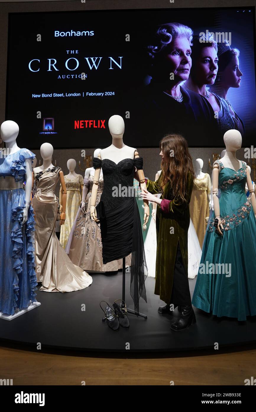 A gallery assistant adjusts a reproduction of Princess Diana's revenge