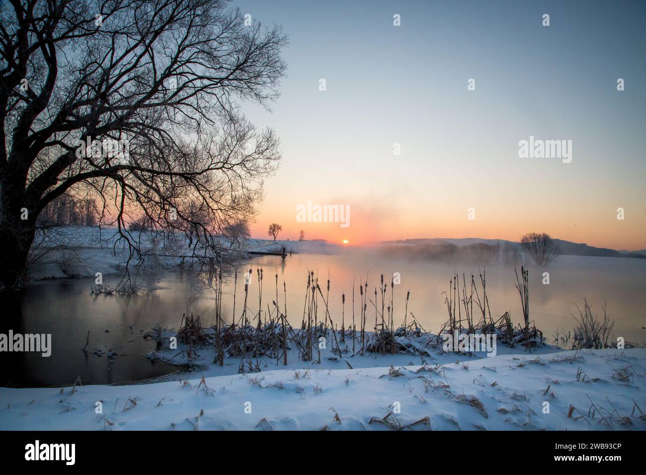 Sunrise over a lake on a cold icy winter morning, Waldviertel, Austria ...