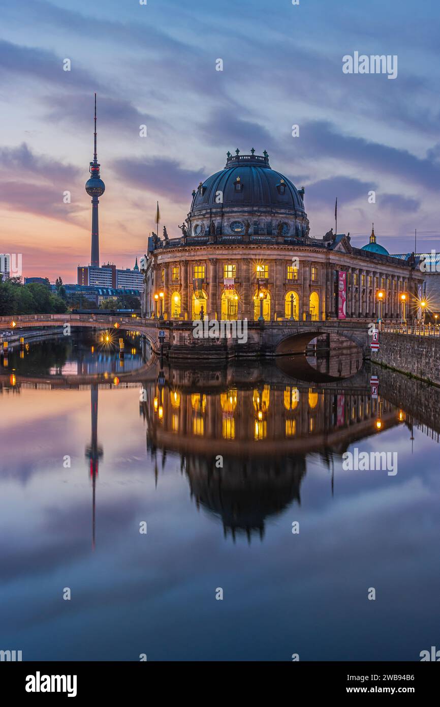 Museum Island in Berlin in the morning. Illuminated buildings and the television tower just before sunrise. Reflections on the water surface Stock Photo