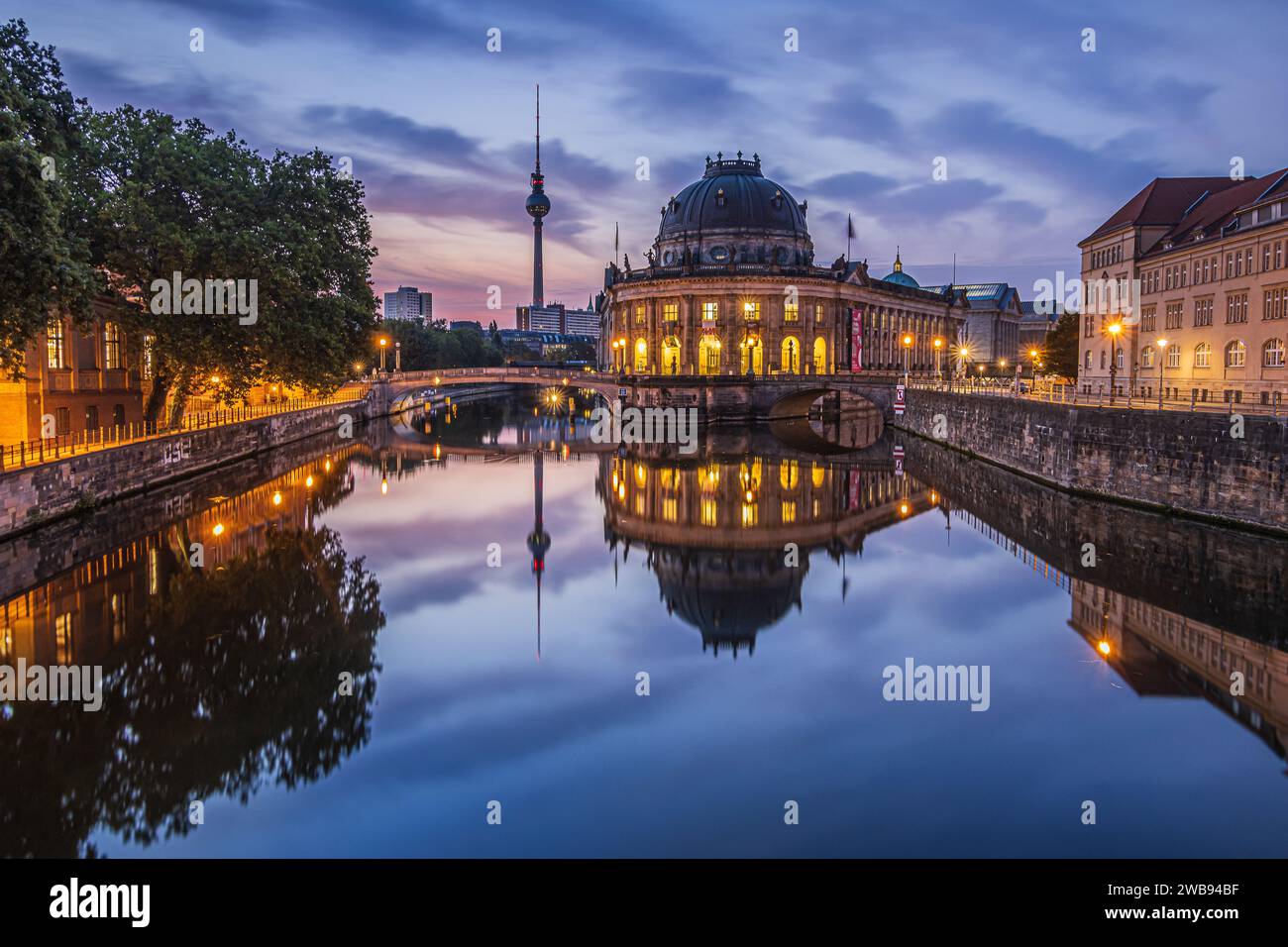 View of Museum Island in the morning at blue hour. Historical buildings with a television tower in the city center of the capital of Germany. Stock Photo