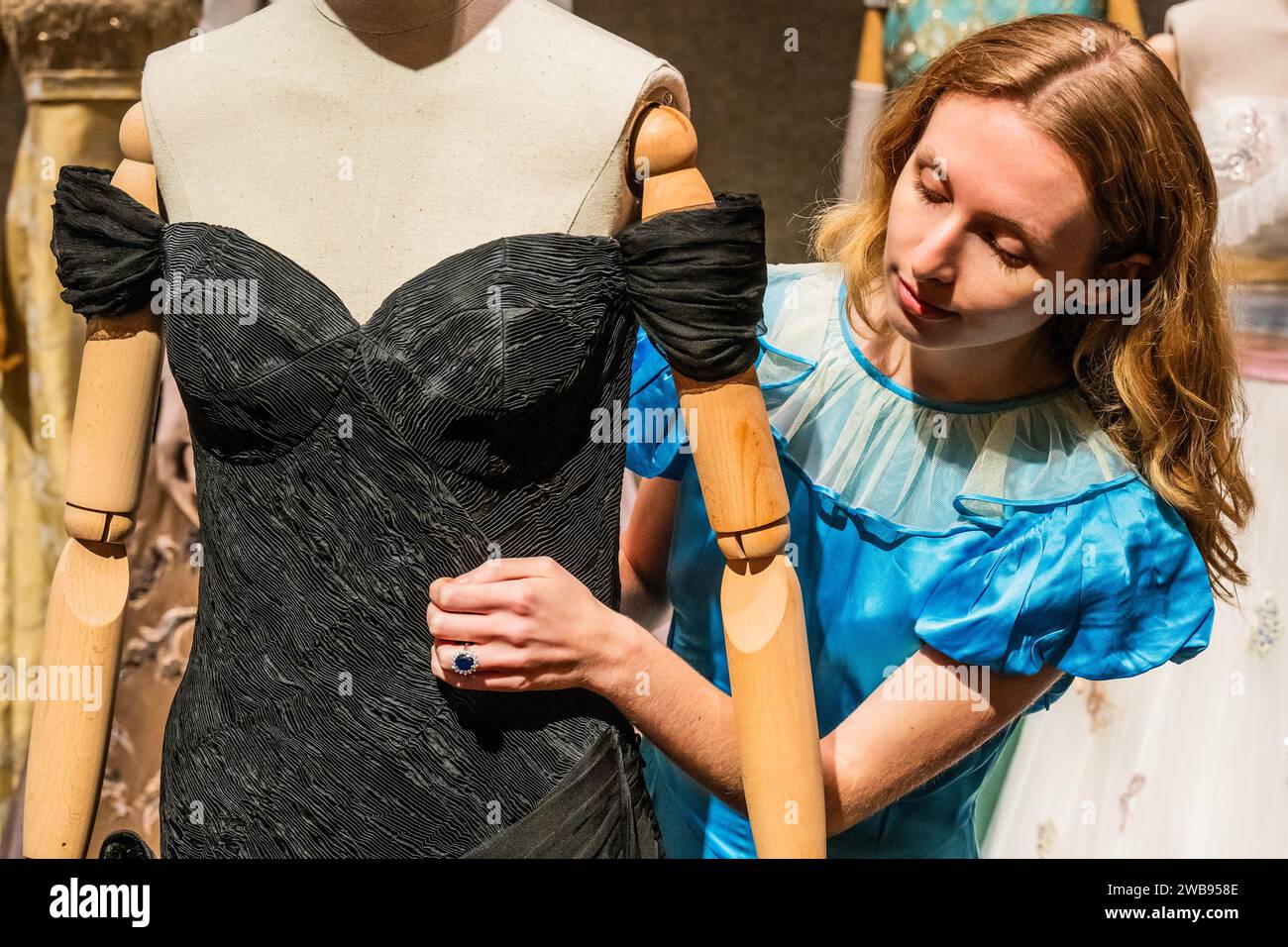 London, UK. 9 Jan 2024. The 'Revenge dress', custom-made off-the-shoulder  black cocktail dress. Worn by Elizabeth Debicki (as Princess Diana) in  Season 5 Episode 5. Estimate: 8,000-12,000 with the Engagement Ring as
