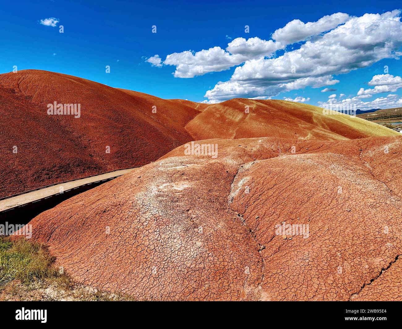 A scenic view of a winding road that leads through a mountainous landscape and transitions into a desert area Stock Photo