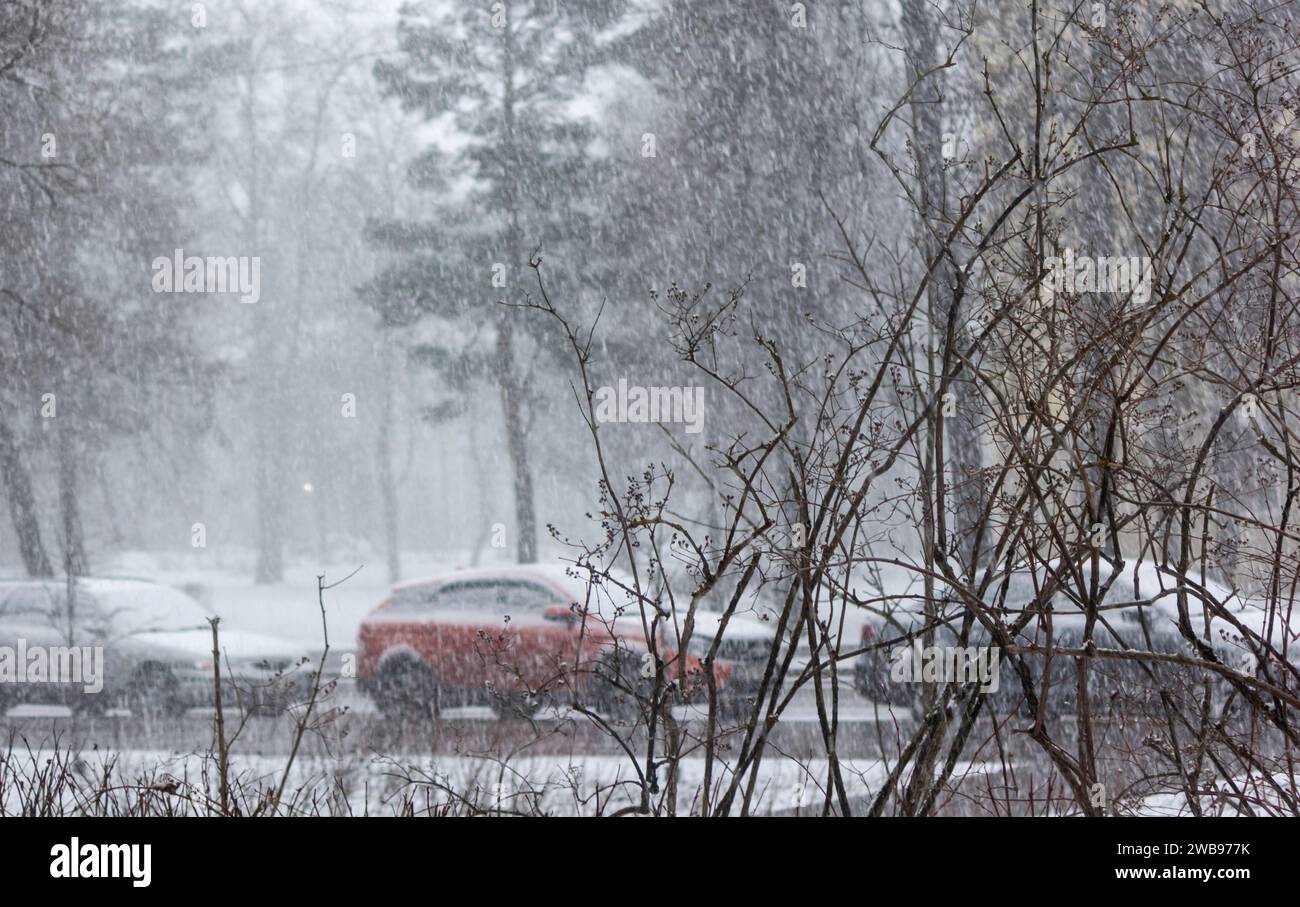 Snow-covered city street during heavy snowfall. There is a lot of snow ...