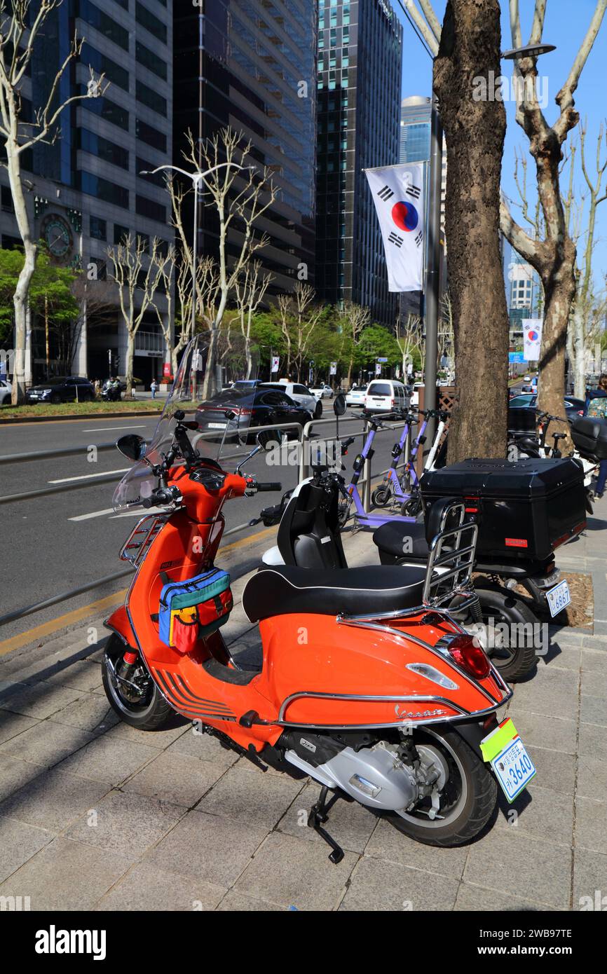 SEOUL, SOUTH KOREA APRIL 7, 2023 Red Vespa scooter parked on Teheranro street in Gangnam
