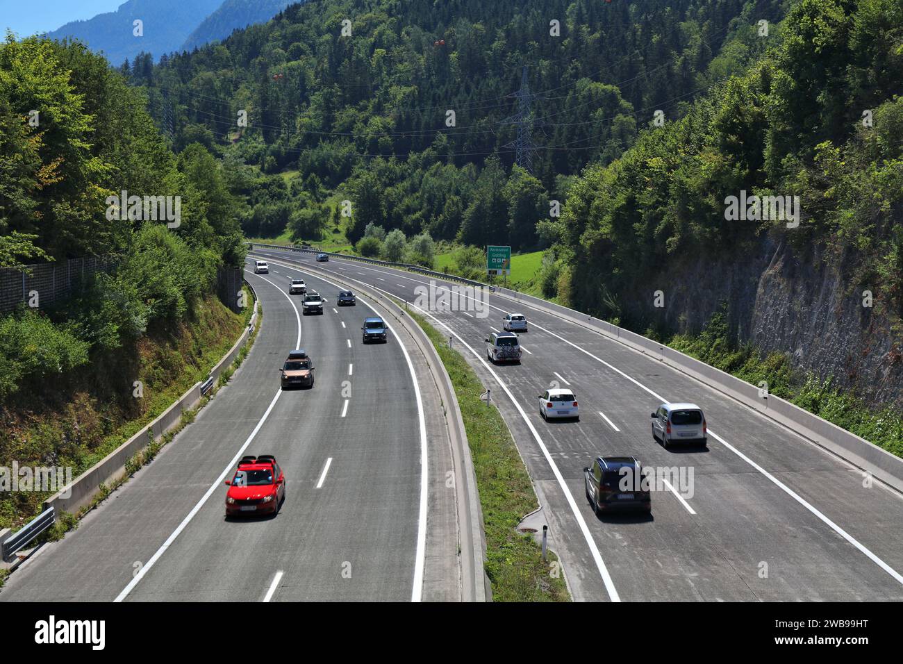 HALLEIN, AUSTRIA - AUGUST 4, 2022: Motorway (Autobahn) near Hallein in Salzburg state in Austria. Banked turn with concrete surface. Stock Photo