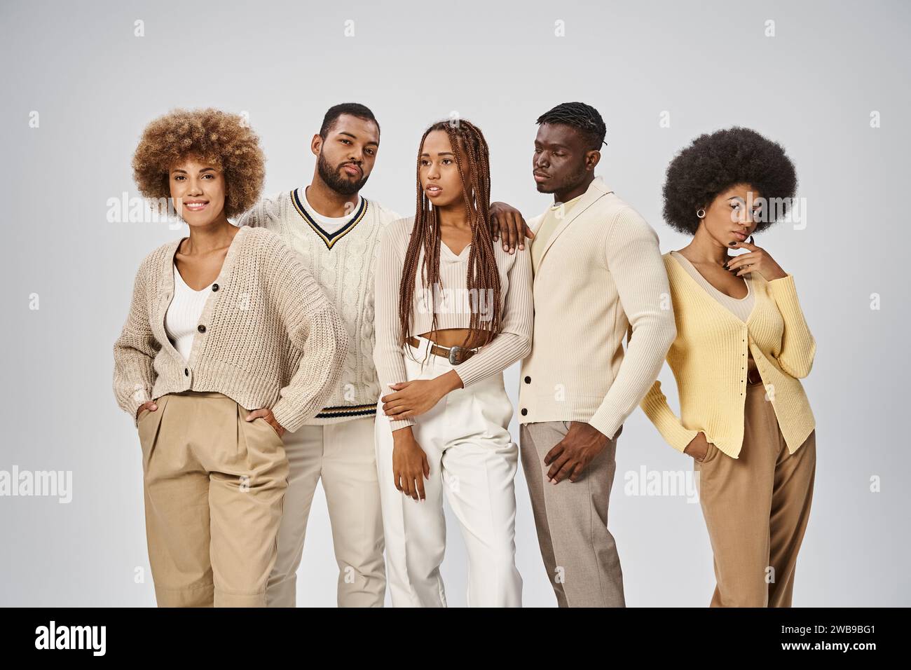 young african american people in casual attire standing on grey ...