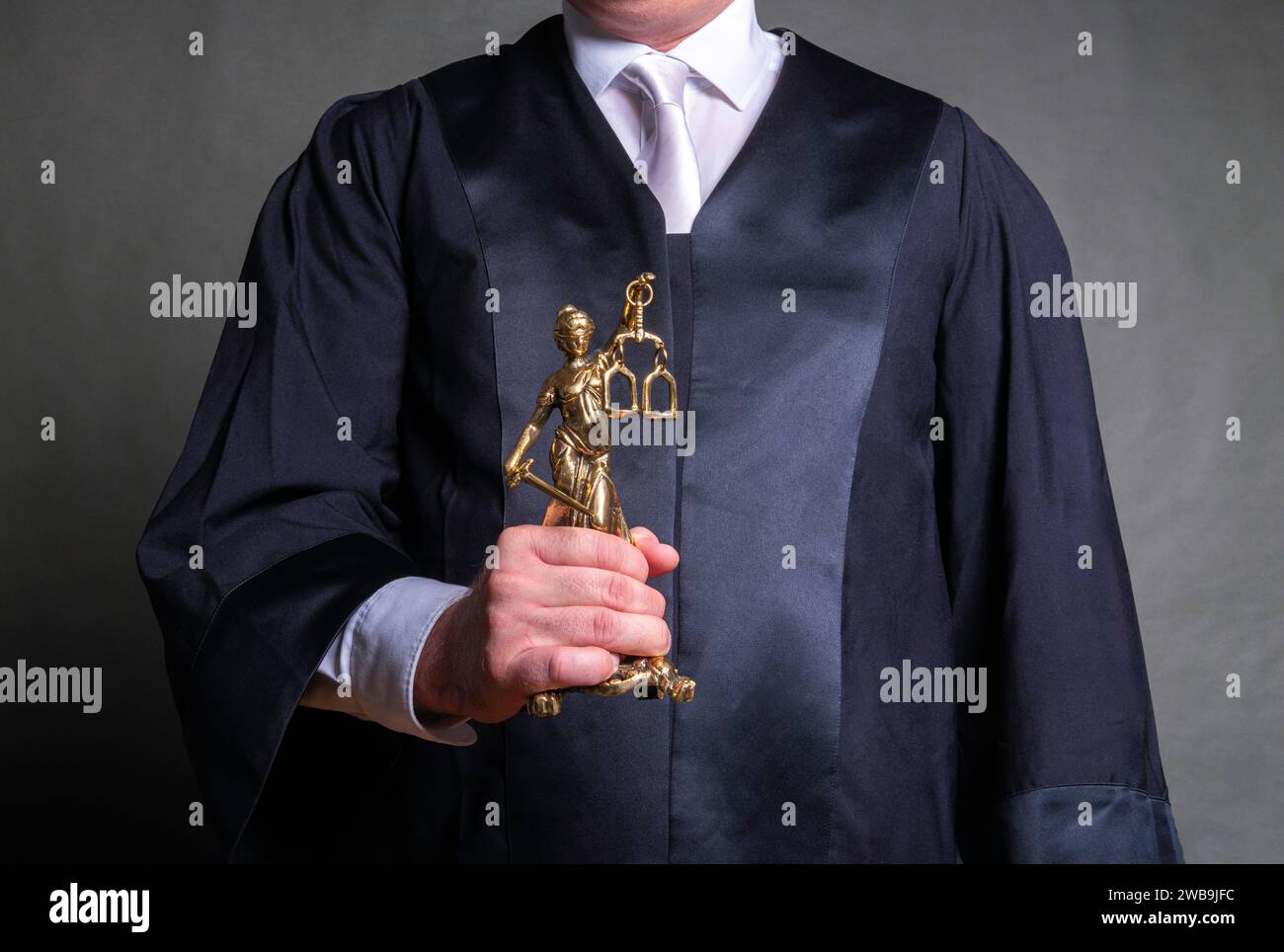 german lawyer with a classical black robe and white tie holding a ...