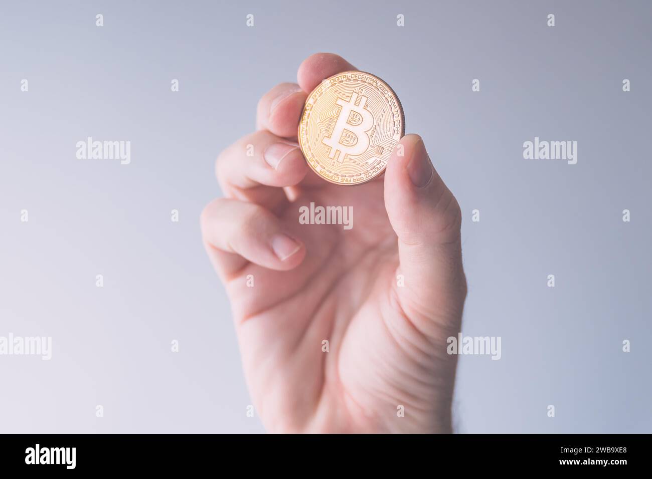 Cryptocurrency trader holding bitcoin BTC coin, business finance and economy concept with selective focus Stock Photo