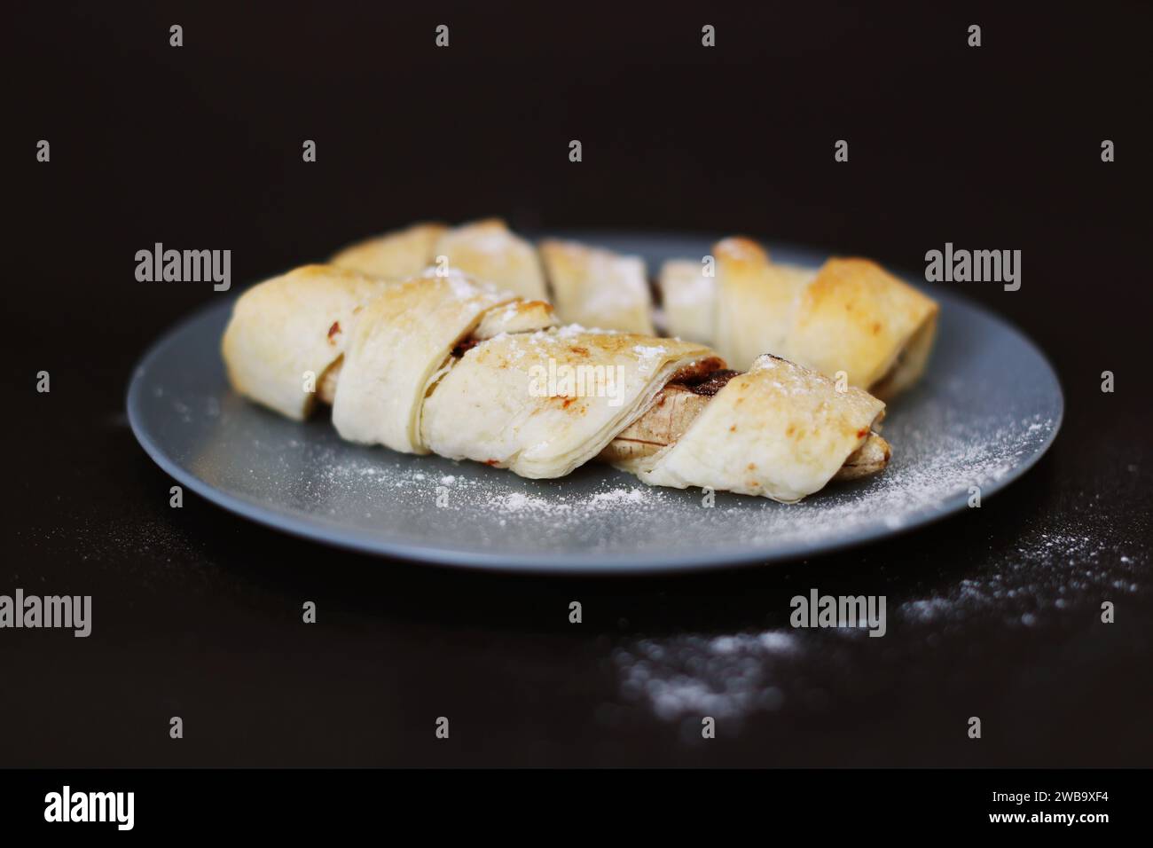 homemade bananas in dough on a black background Stock Photo