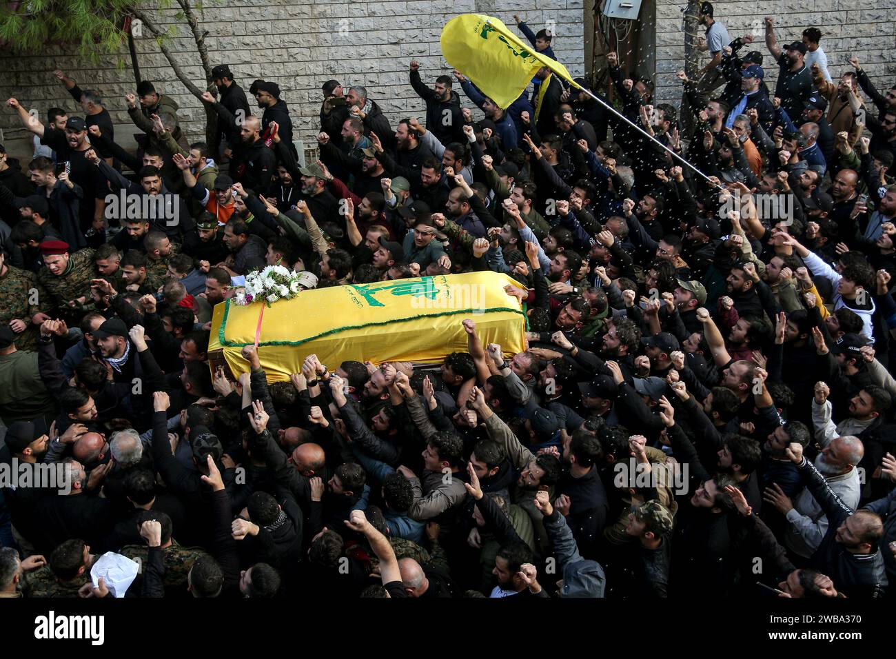 Khirbet Selm, Lebanon. 09th Jan, 2024. Pro-Iranian Hezbollah supporters carry the coffin of the party top commander Wissam Tawail during his funeral procession in the southern Lebanese village of Khirbit Selem. Tawil is the highest-ranking Hezbollah commander to be killed since the eruption of the cross-border conflict between Israel and Hezbollah in Lebanon on October 8, and the second high-profile assassination to take place in Lebanon in two weeks. Credit: Marwan Naamani/dpa/Alamy Live News Stock Photo