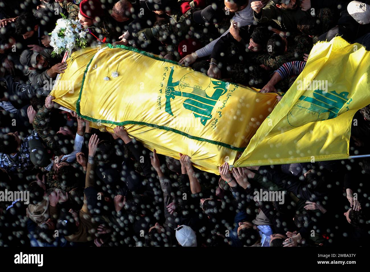 Khirbet Selm, Lebanon. 09th Jan, 2024. Pro-Iranian Hezbollah supporters carry the coffin of the party top commander Wissam Tawail during his funeral procession in the southern Lebanese village of Khirbit Selem. Tawil is the highest-ranking Hezbollah commander to be killed since the eruption of the cross-border conflict between Israel and Hezbollah in Lebanon on October 8, and the second high-profile assassination to take place in Lebanon in two weeks. Credit: Marwan Naamani/dpa/Alamy Live News Stock Photo