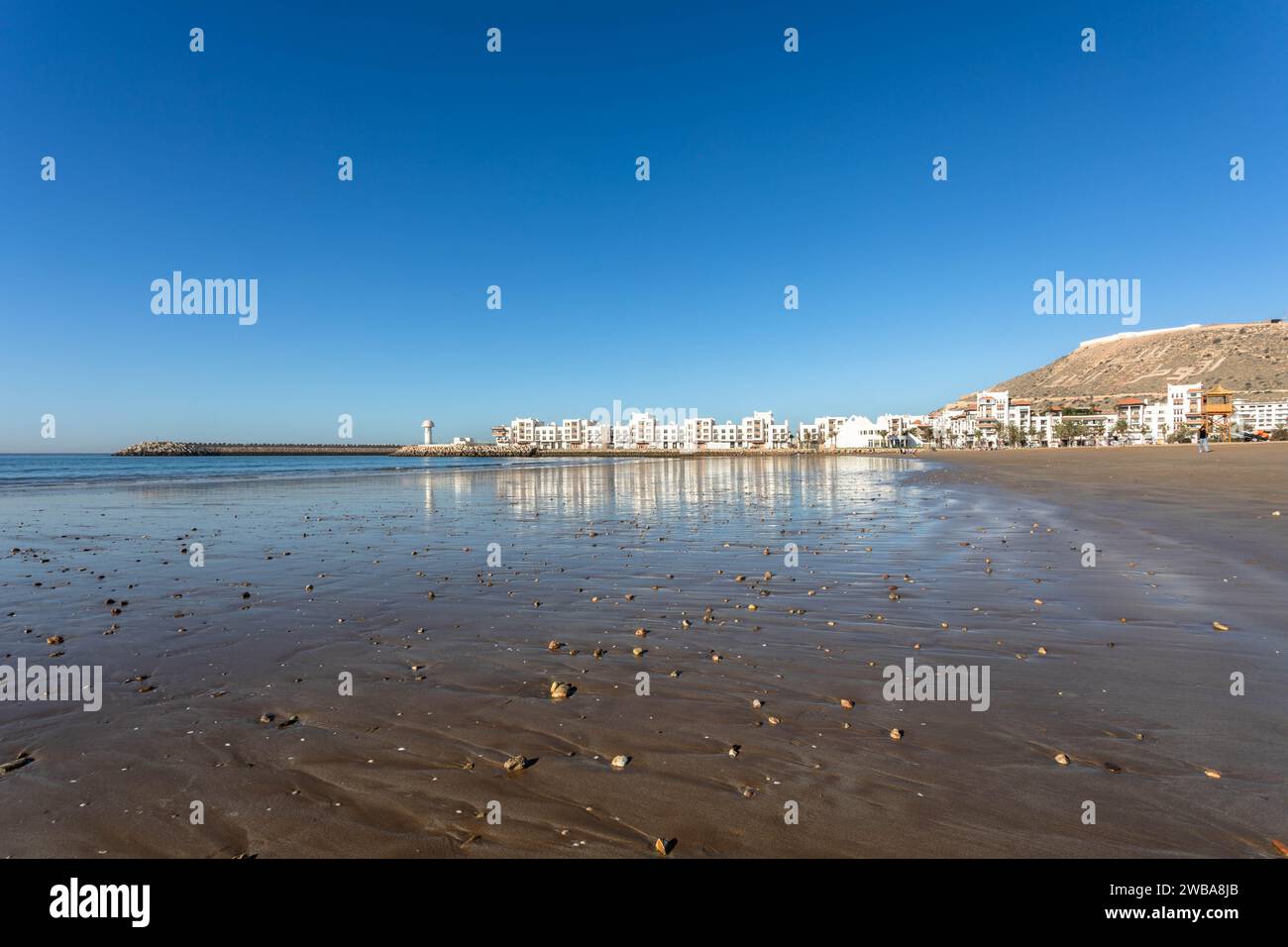 Panoramic view of Agadir Beach with tide going out, with Kasbah and Marina in the distance Stock Photo