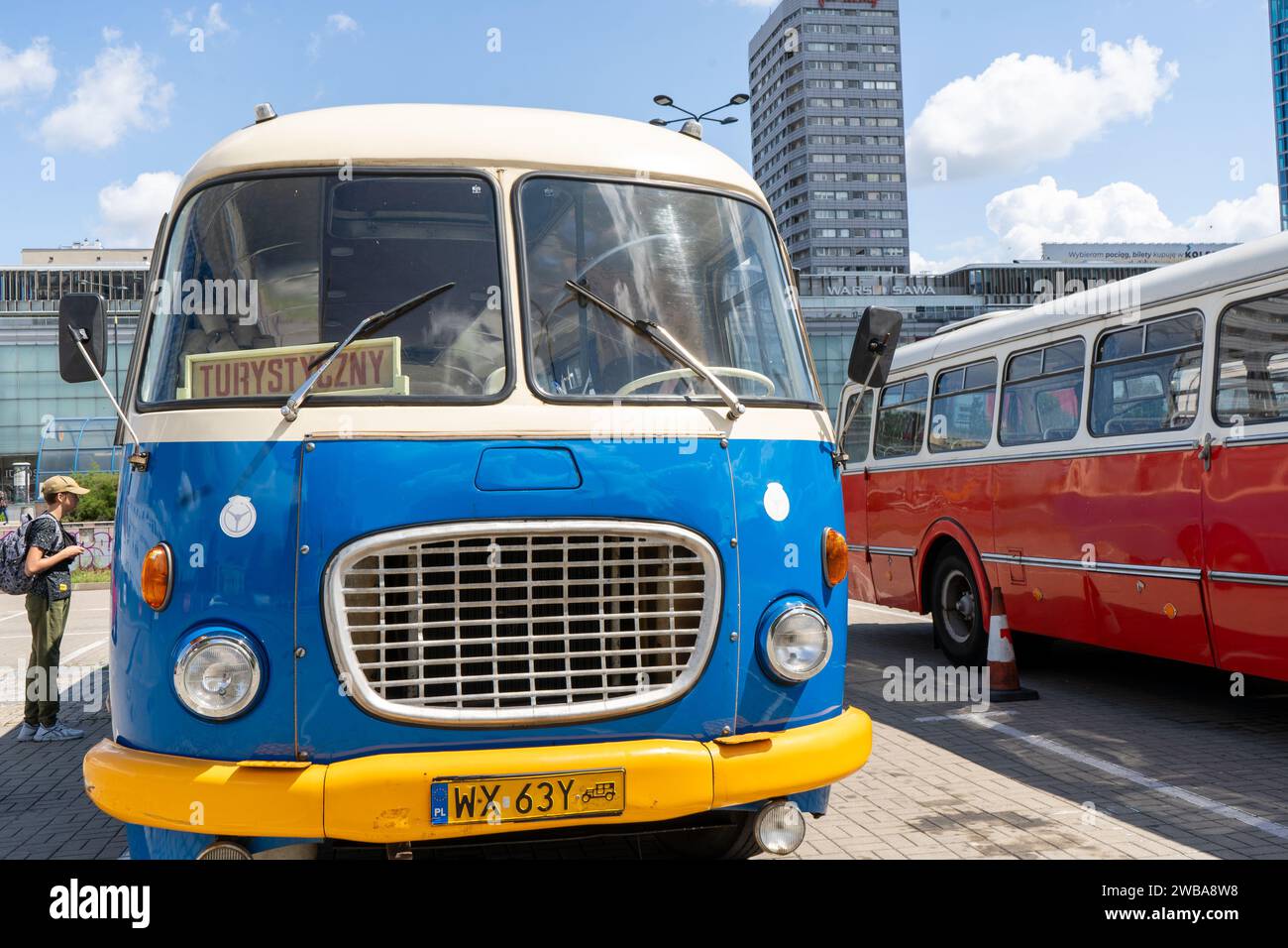 The old red and blue Skoda bus. Czechoslovakian Skoda RTO 706 Karosa model. Tourist buses vintage model. The street of the old city is a tourist attraction. Poland, Warsaw - July 27, 2023. Stock Photo