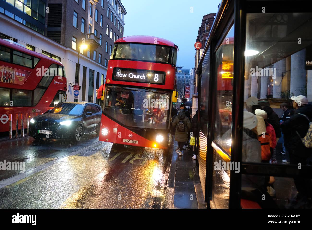 London UK Transport for London TFL double deck bus at a bus stop on a winters evening in the rain taken January 2024 Stock Photo
