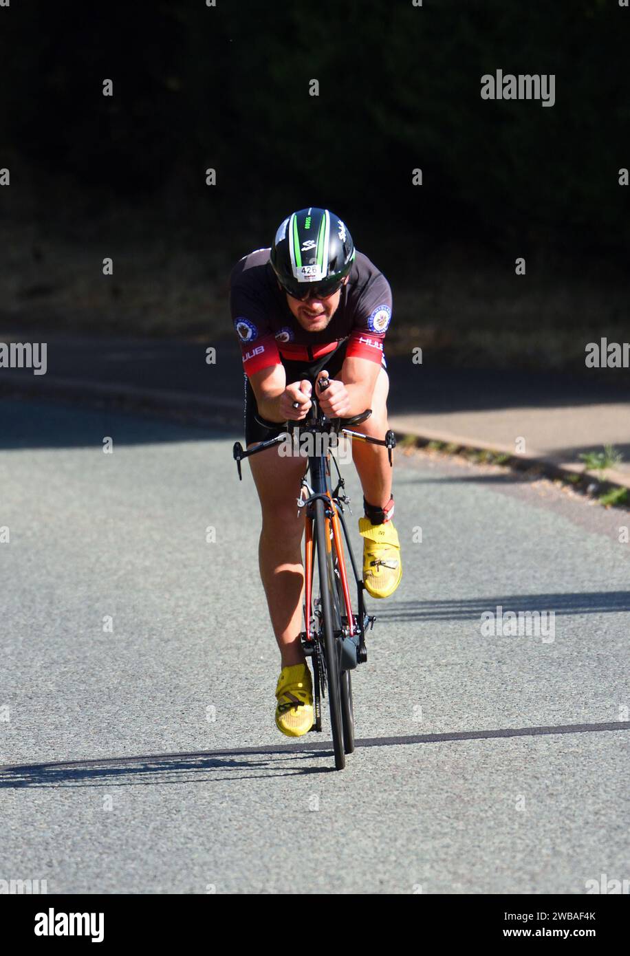 Close up of Male triathlete  competitor on road cycling stage Stock Photo