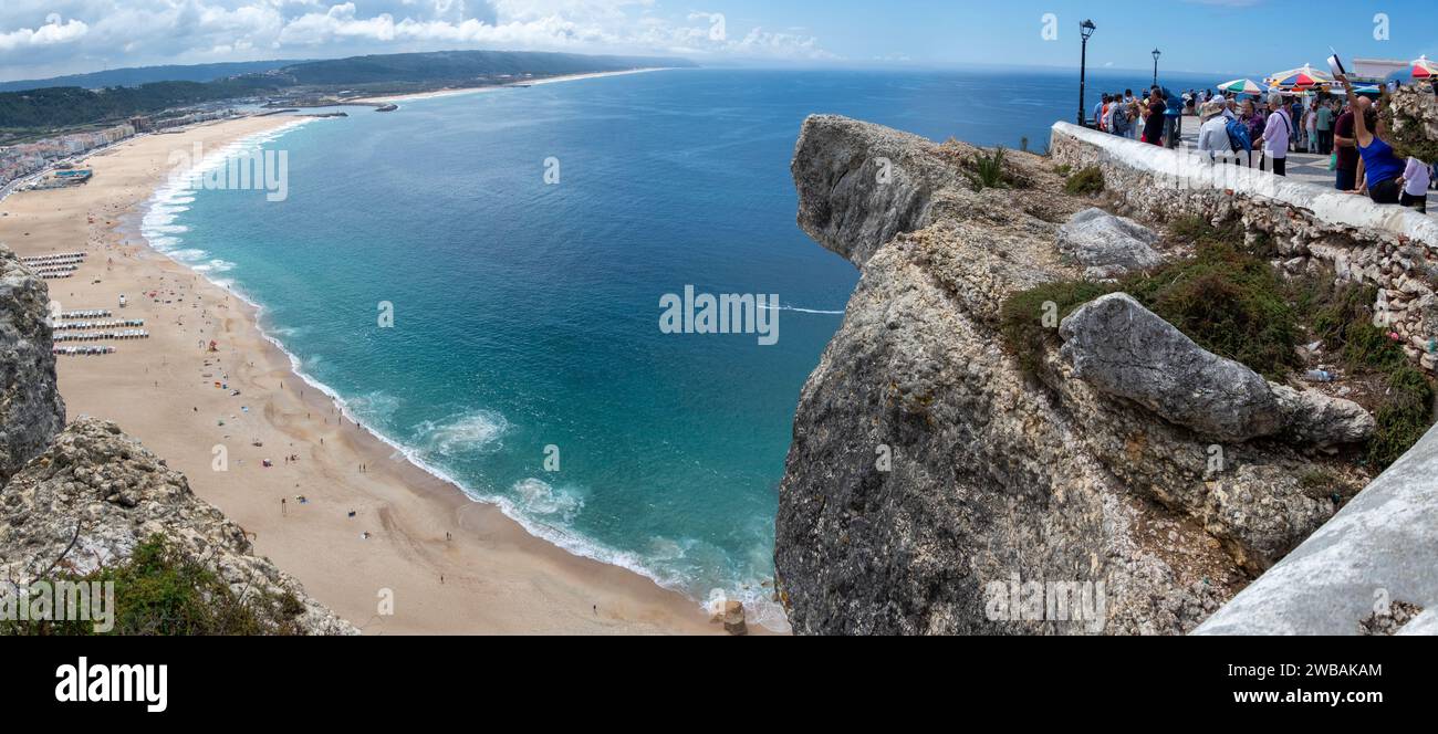 Beach and view with the overhanging cliff edge at the sitio section of Nazare Portugal Stock Photo