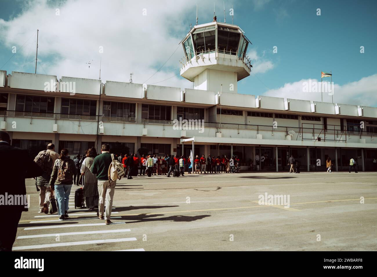 A group of people against Nampula International Airport in Mozambique Stock Photo