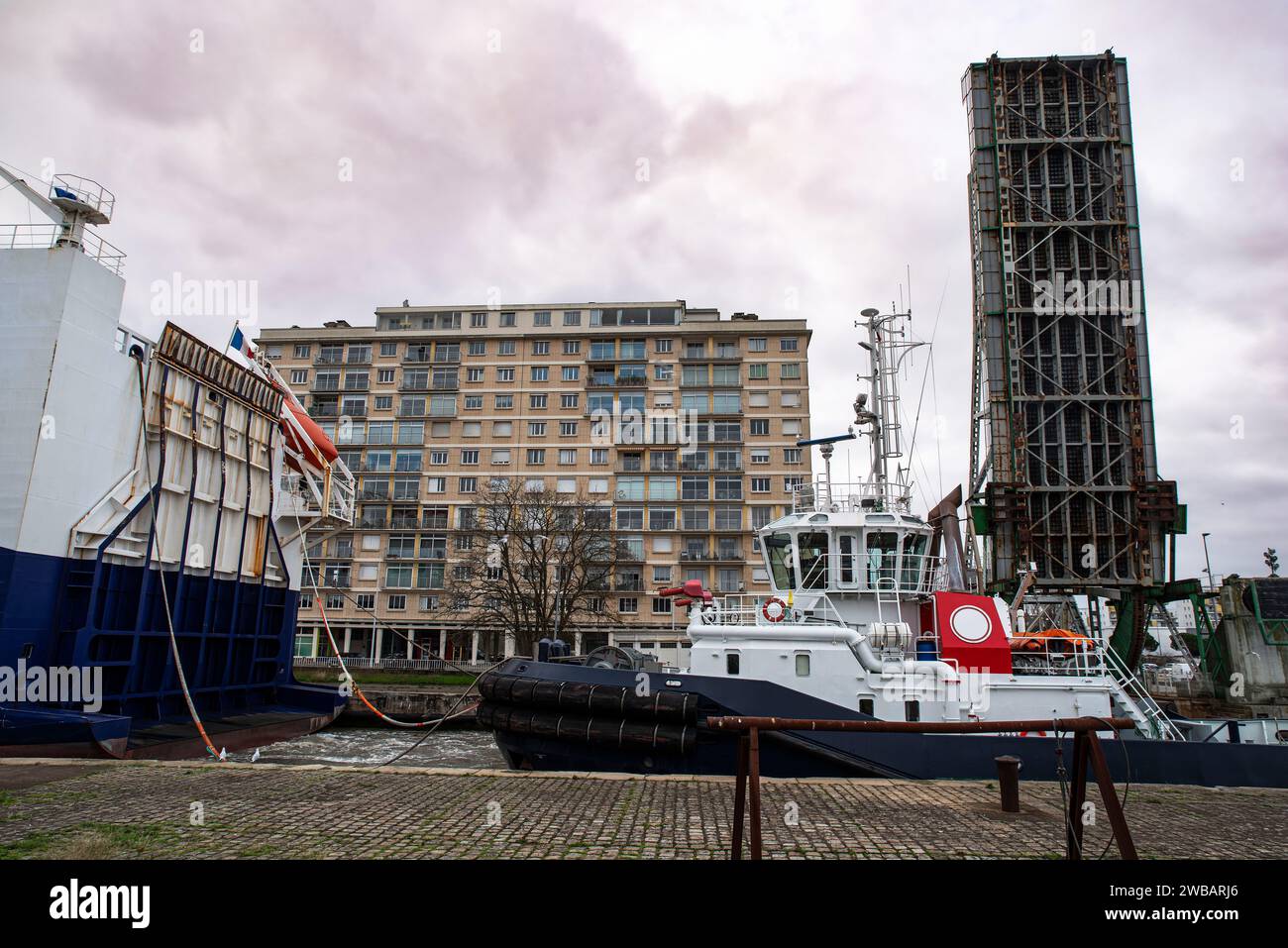 Tugboat, cargo ship and drawbridge in the port of SaintNazaire in