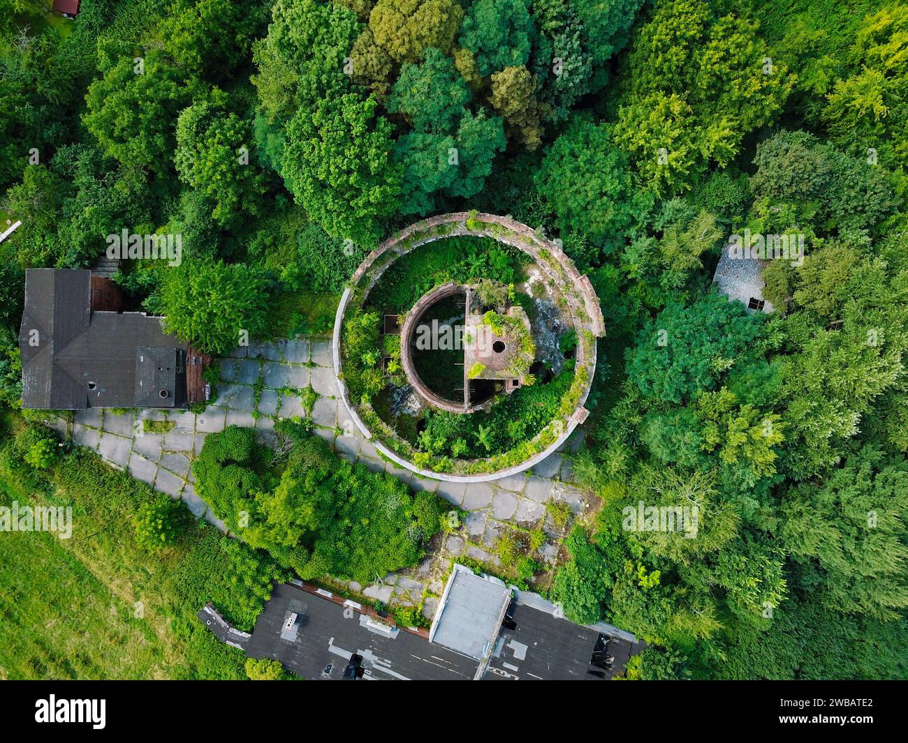 An abandoned old military building, photographed by a drone while nature is slowly taking it back Stock Photo