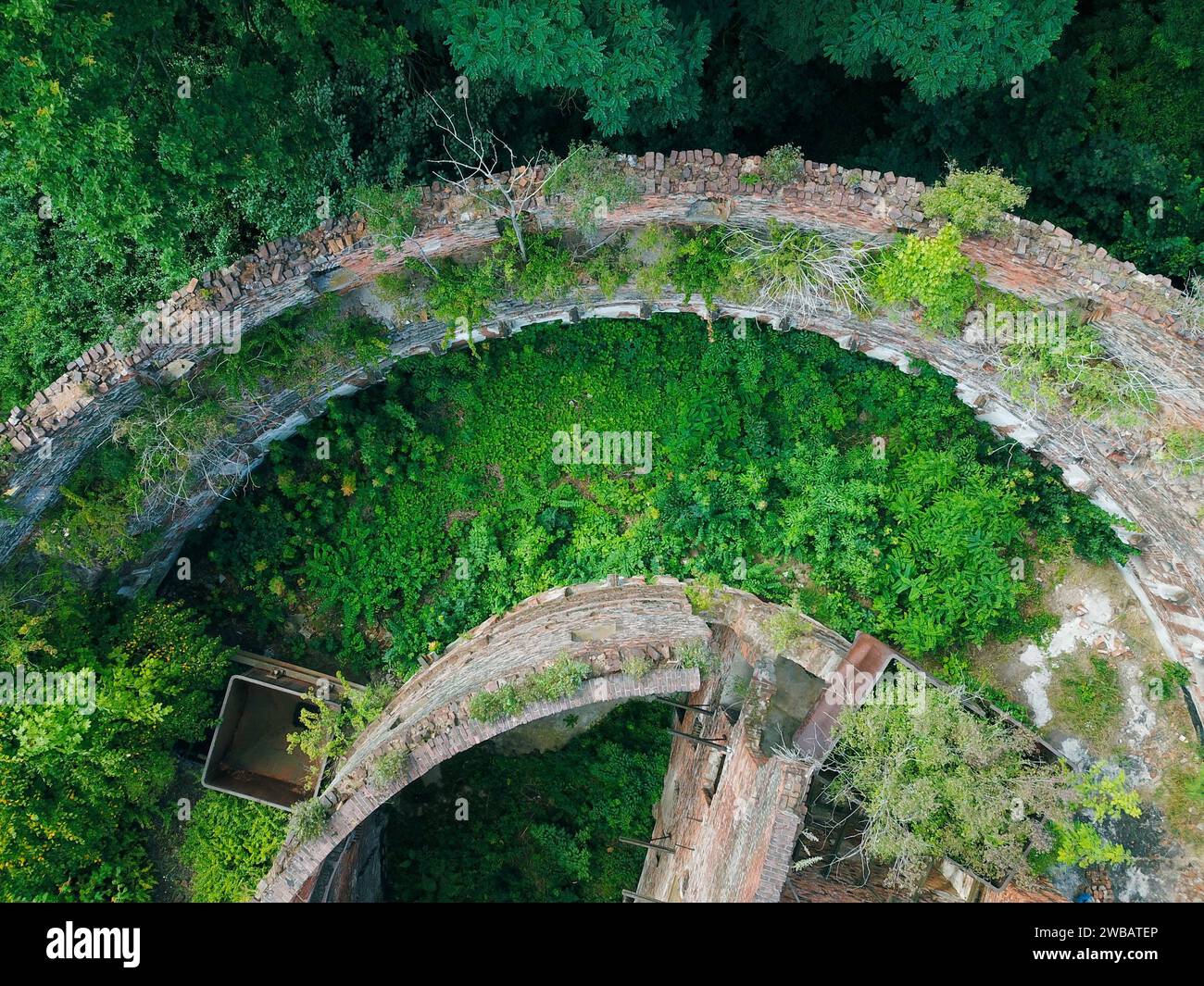 An abandoned old military building, photographed by a drone while nature is slowly taking it back Stock Photo