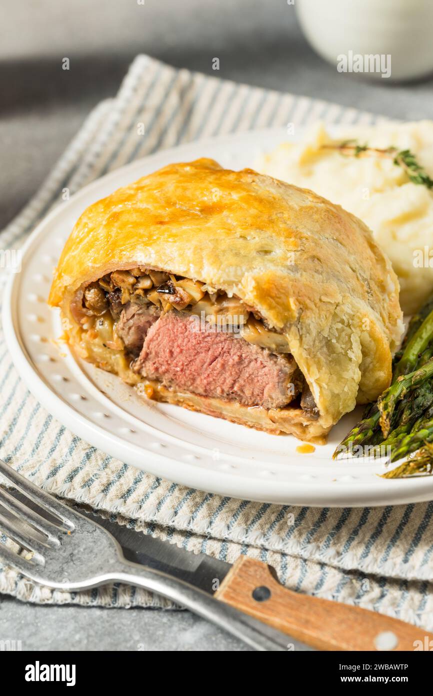 Homemade Individual Beef Wellingtons with Asparagus and Potatoes Stock Photo