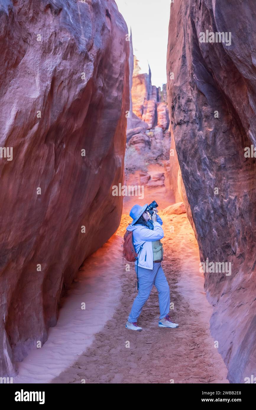 travel photographer in slot canyon taking photo Stock Photo