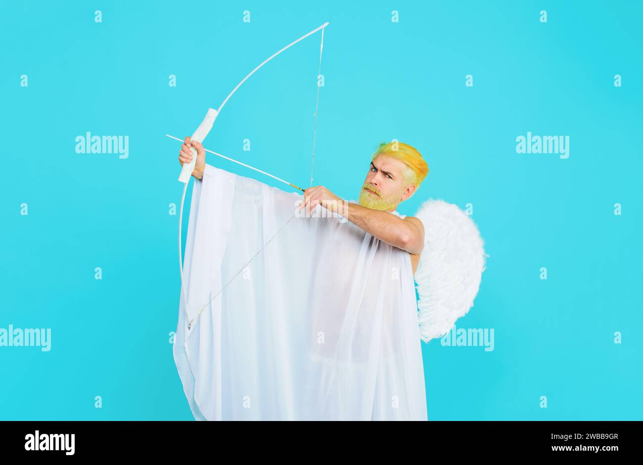 Happy Valentines Day. Serious bearded man in angel costume with bow and arrows. Valentines day cupid angel shooting arrows of love. Male cupid in Stock Photo
