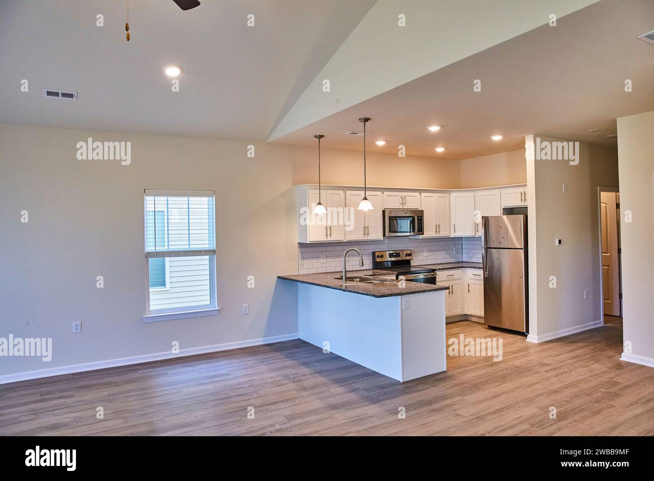 Modern Kitchen with Island and Open Living Area, Natural Light Stock