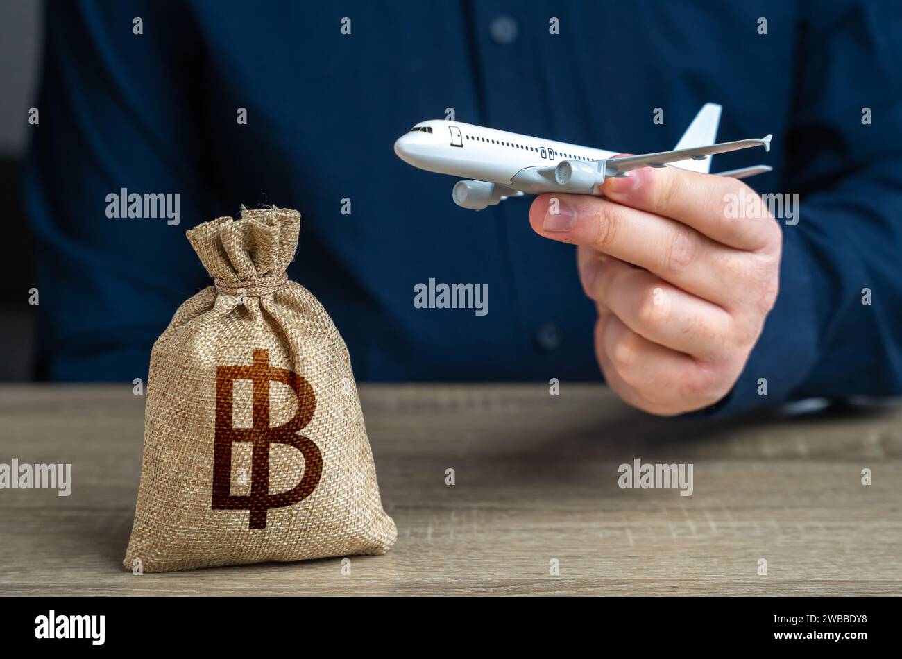 Airplane flights and thai baht money bag. Airline industry income. Budget allocations. Investments in the development of the air transport industry an Stock Photo