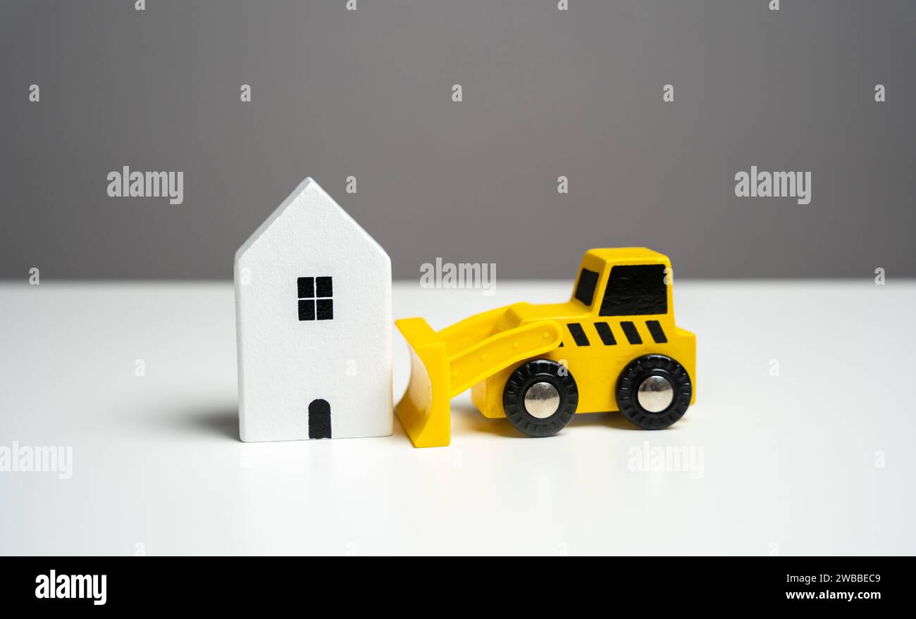 Bulldozer demolishes house, concept. Illegal buildings construction. Plan for the renewal and