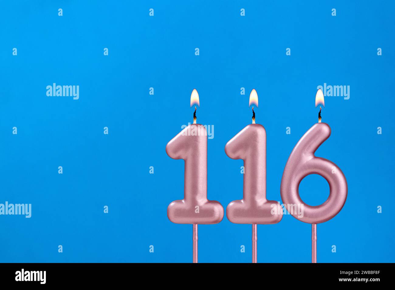 Number 116 - Burning anniversary candle on blue foamy background Stock ...