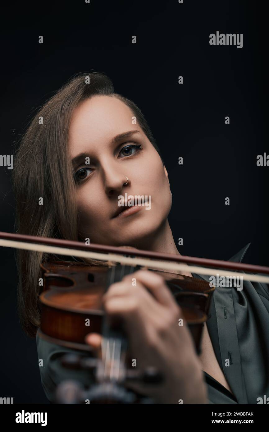 Focused musician brings to life the unique timbre of a Baroque violin, celebrating its timeless beauty Stock Photo