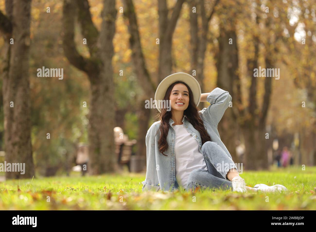 Woman sitting on green hi-res stock photography and images - Alamy