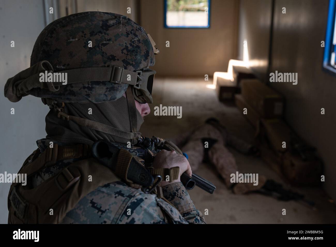 U.S. Marine Corps Lance Cpl. Anthony Vengley, an infantry marine with Battalion Landing Team 1/1, 31st Marine Expeditionary Unit, posts security over a simulated casualty while conducting military operations on urbanized terrain training at Camp Hansen, Okinawa, Japan, Jan. 5, 2024. MOUT training provides the organization, planning, and knowledge needed to be successful when conducting operations in an urban environment. The 31st MEU, the Marine Corps’ only continuously forward-deployed MEU, provides a flexible and lethal force ready to perform a wide range of military operations as the premie Stock Photo