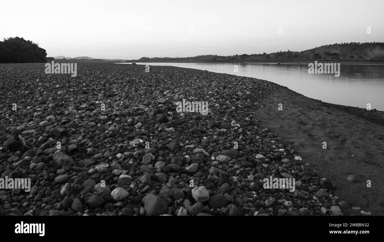 A black and white photograph of a stony shore in Tinapuay, Banga, Aklan, Philippines. Stock Photo