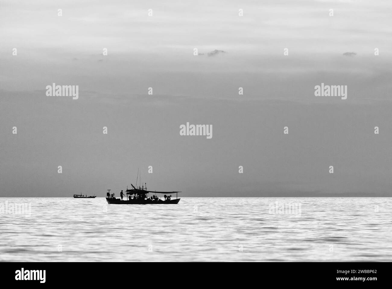 Fisherman silhouette in boat Black and White Stock Photos & Images - Alamy