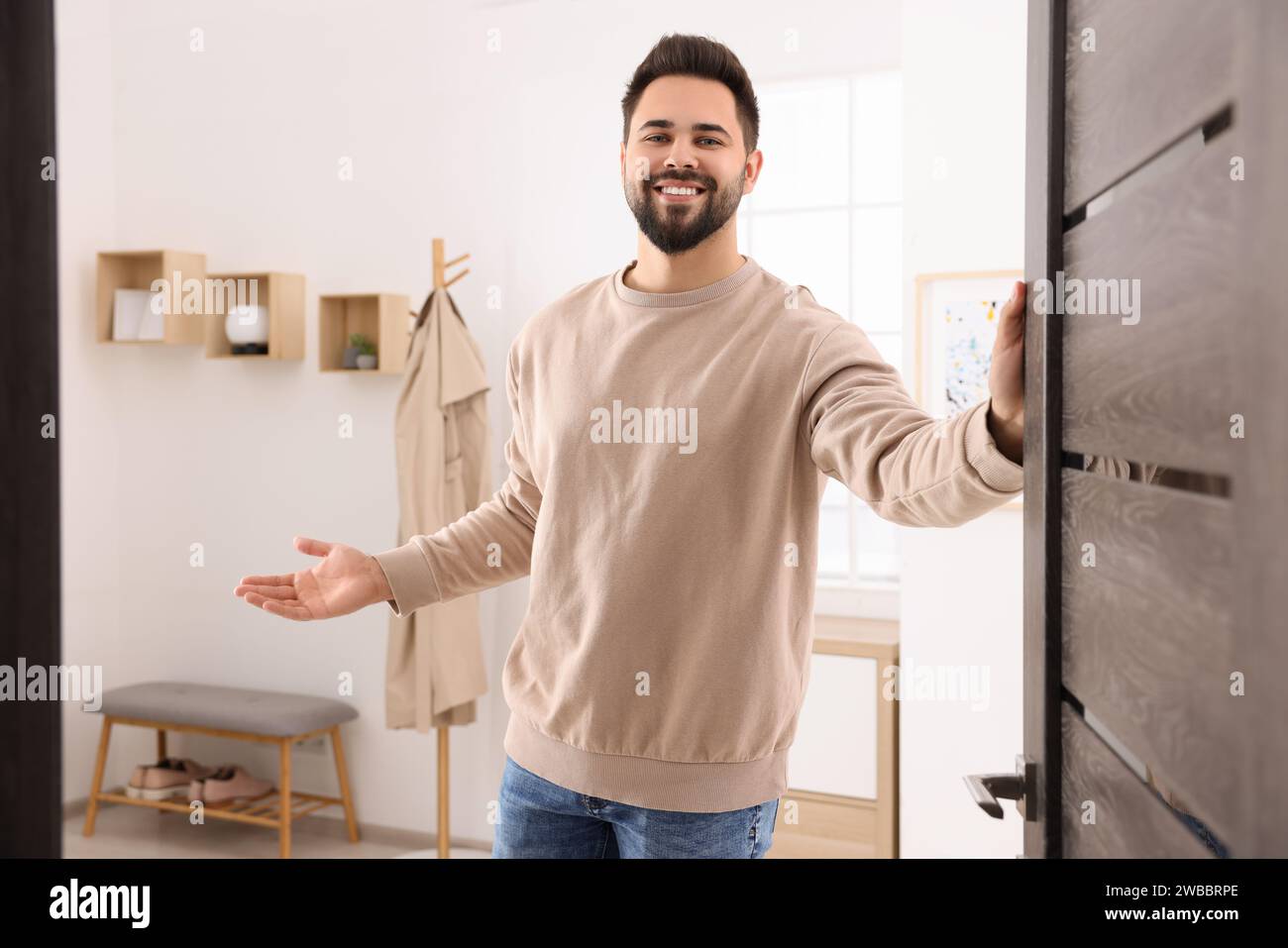 Greeting friend at door hi-res stock photography and images - Alamy