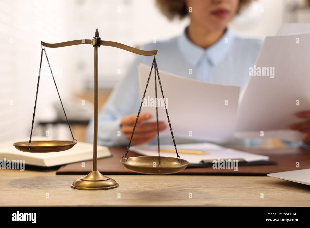 Notary with documents at workplace in office, focus on scales of ...