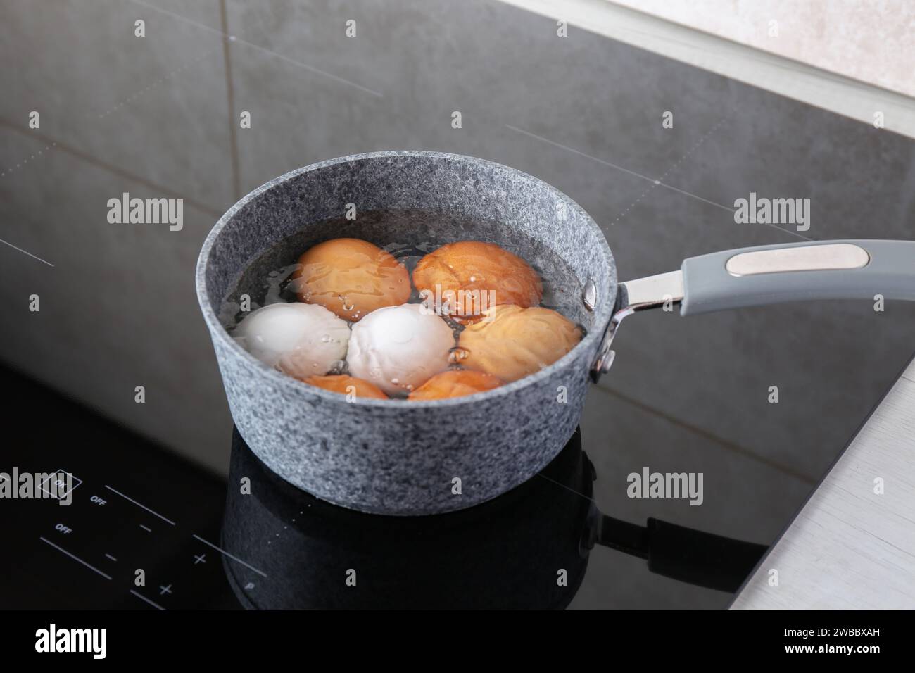 Chicken eggs boiling in saucepan on electric stove Stock Photo Alamy