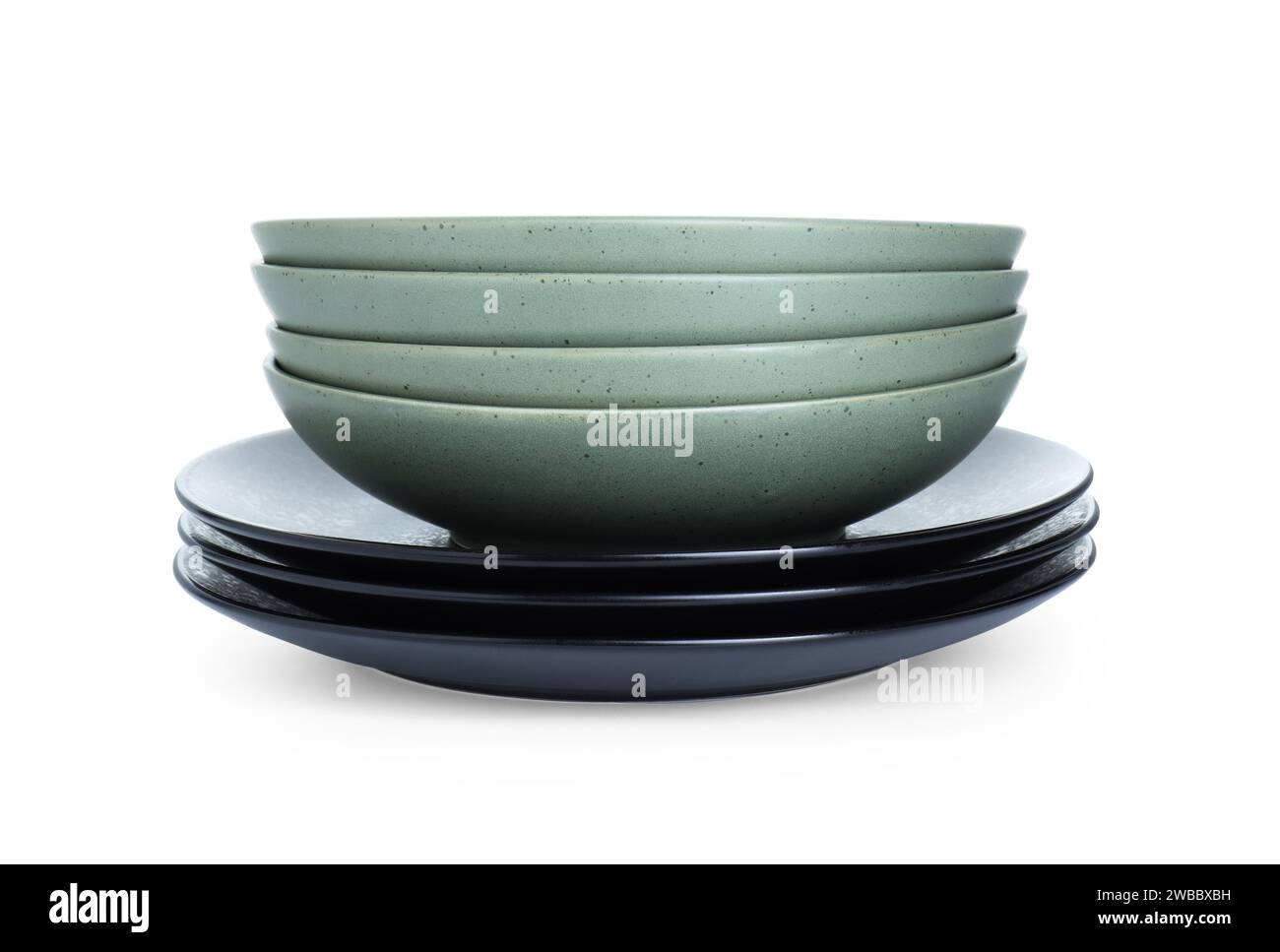 Stack of beautiful ceramic plates and bowls isolated on white Stock