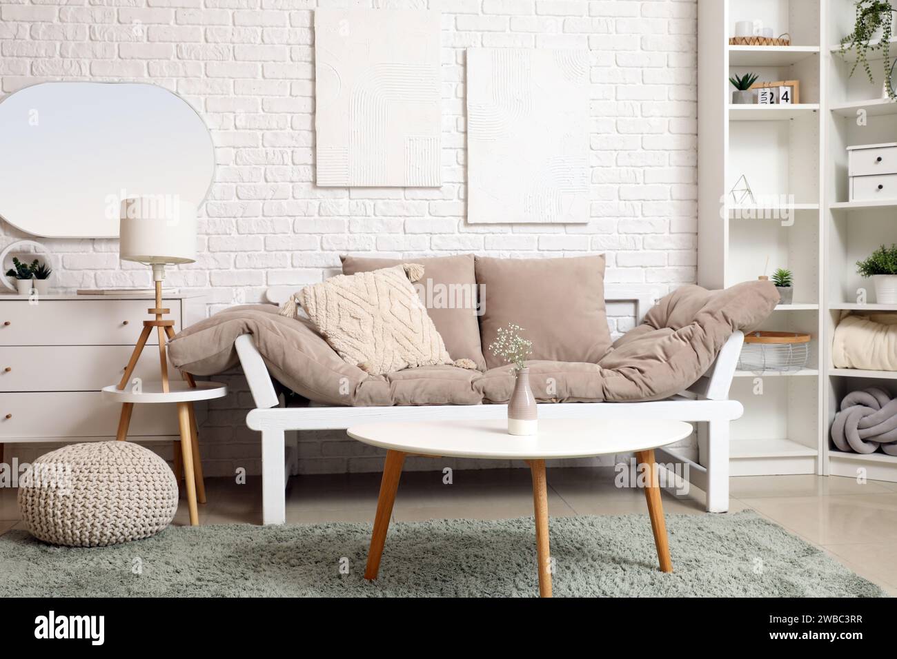 Interior of light living room with sofa, coffee table and mirror Stock ...