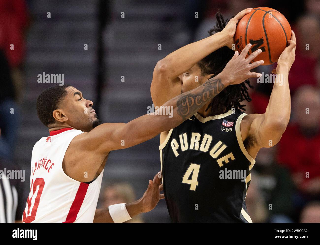 Nebraska's Jamarques Lawrence, left, guards Purdue's Trey KaufmanRenn during the first half of